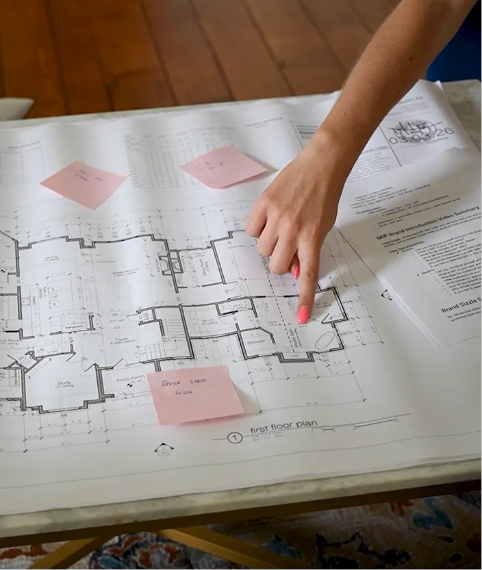 MIP employees pointing at floor plan