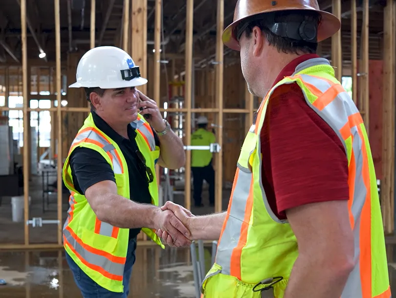 men shaking hands on work site